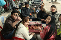 A group of locals enjoying the fun communal activity of peeling garlic!
