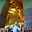 Apparently doing a gay dance below the head of the largest reclining golden Buddha in Thailand.