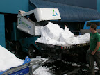 The zambezi dumping a load of snow/ice shavings onto the truck at the ice skating rink
