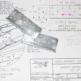 C-613 splice plates.  Drill highlighted holes in assembly with the C-702.  I learned the hard way, if you pre-drill them all (per the plans) you end up with one hole very close to another.  My replacements were made from Aircraft Spruce part 03-48700.