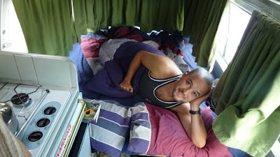 Alex waking up in our campervan
