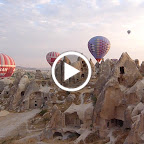 Photo of a hot air balloon over the rock formations in the Cappadocia region