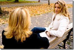 two-women-talking-on-bench