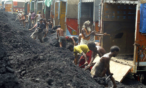 Laborers load coal onto trucks on the outskirts of Jammu, India. Photo by Channi Anand: AP