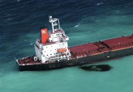 Oil is seen next to the 230-metre (754-ft) bulk coal carrier Shen Neng I about 70 km (43 miles) east of Great Keppel Island April 5, 2010. REUTERS / Maritime Safety Queensland / Handout