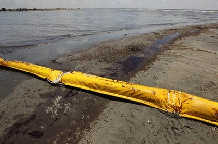 Oil from the Deepwater Horizon oil spill that got past booms washes ashore on Elmer's Island in Grand Isle, Louisiana, 21 May 2010. AP / Gerald Herbert