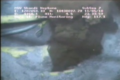 This image from a video released by BP PLC shows oil spewing from a yellowish, broken pipe 5,000 feet below the surface. (AP Photo / BP PLC)