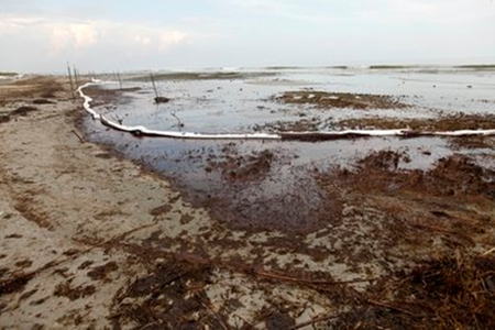 Oil absorbent material boom and oil from the Deepwater Horizon oil spill is seen on Elmer's Island in Grand Isle, La. on Tuesday, May 25, 2010. (AP Photo / Gerald Herbert)