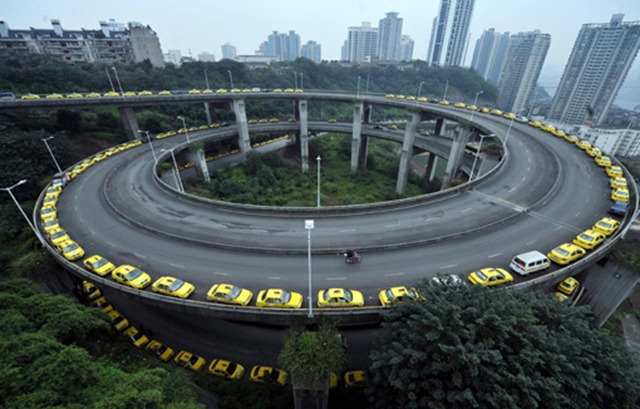 Taxis queue up to fill their tanks on an overpass in Chongqing, China, Wednesday, November 18, 2009. Central and eastern Chinese provinces faced the worst natural gas shortage in years as supplies were diverted to snowstorm-hit northern China, while producers lacked incentives to expand output because of poor margins. Photo by Imaginechina: AP