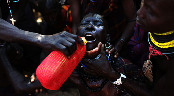 An elderly woman is given water in the Turkana region of Kenya. Many of the elderly are too weak and sick to feed themselves or drink. Jehad Nga for The New York Times
