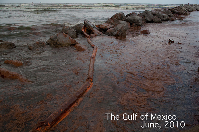 Oil from the BP Deepwater Horizon well coats a beach on Grand Isle, Louisiana, early June 2010. A failed boom stretches through the toxic muck. Andy Levin