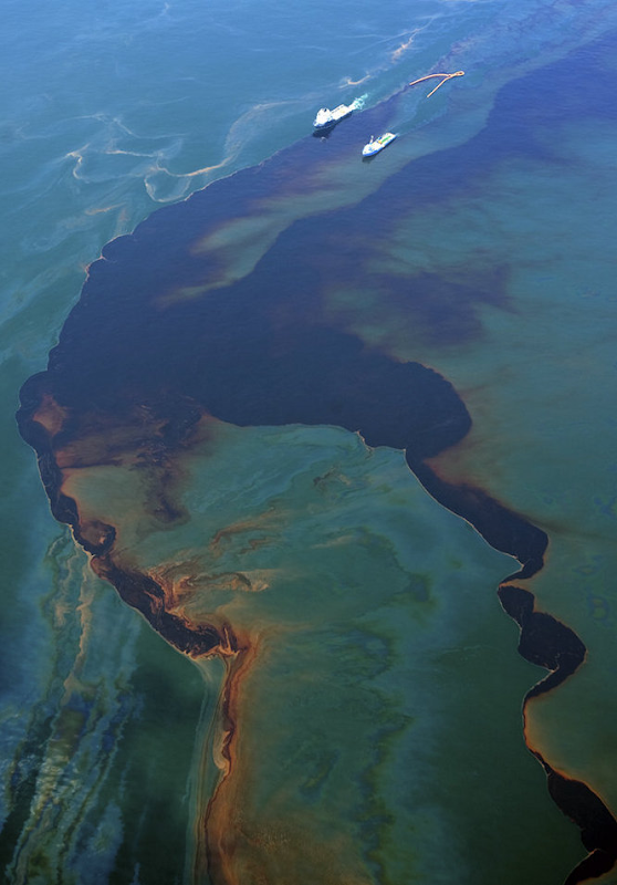 A couple of boats pull a oil collecting boom between them through a heavy oil slick from the Deepwater Horizon oil spill site, Monday, May 14, 2010. PHOTO BY TED JACKSON / THE TIMES-PICAYUNE