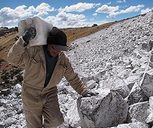 Workers carry whitewash mortar to peaks over 4,700 meters of altitude in the Peruvian Ande. Photo courtesy AFP.