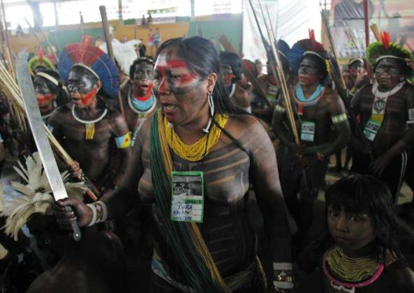 An Amazonian Indian woman with a machete during the protest by indigenous people in Altamira, Brazil. AP via independent.co.uk