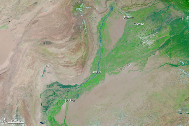 In this MODIS image from 10 July 2010, a combination of infrared and visible light is used to increase the contrast between water and land. Water appears in varying shades of blue, and clouds appear in varying shades of blue-green. Vegetation is green, and bare ground is pinkish brown. The relatively narrow Indus River remains confined to its banks, and the Jhelum and Chenab Rivers, which flow into the Indus, are barely discernible. NASA image courtesy the MODIS Rapid Response Team at NASA GSFC. 