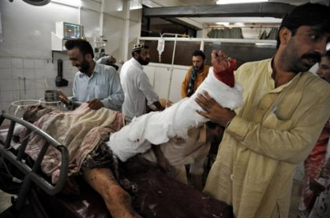 Man receives treatment after being injured by suicide bombing in Peshawar, Pakistan, 23 Aug 2010. AFP