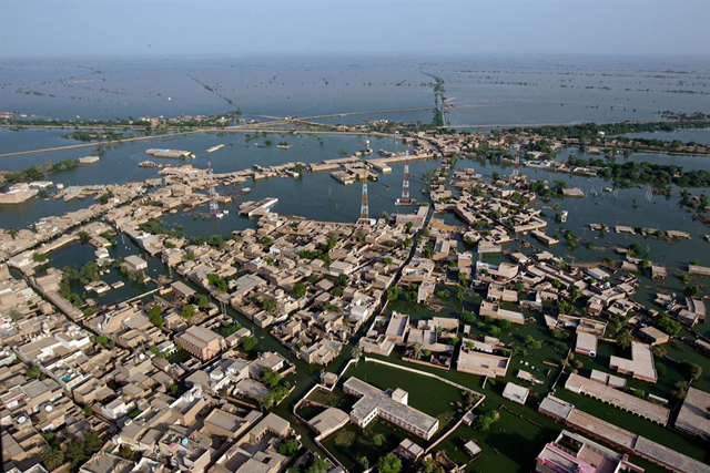 A Pakistan Army helicopter flies over the Garhi Khairoo, area near the new flood zone of Shahdakot, Pakistan on Sunday. The country's agricultural heartland has been devastated, with rice, corn and wheat crops destroyed by floods. Paula Bronstein / Getty Images
