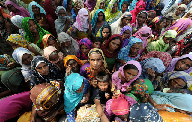 Internally displaced Pakistani women wait for relief goods in Larkana on September 3, 2010. Relief efforts in flood-ravaged Pakistan are being stretched by the 'unprecedented scale' of the disaster, while funding has almost stalled, the UN said on September 2, 2010. ADEK BERRY / AFP / Getty Images
