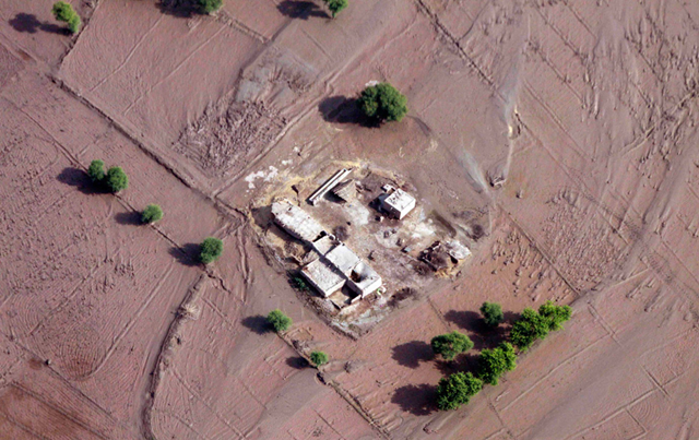 An aerial view shows the mudflow surrounding a house as floodwaters recede in some parts of the Rajanpur district of Punjab province, Pakistan on Sunday Sept. 5, 2010. AP Photo / Aaron Favila