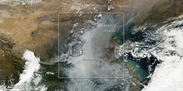 On October 8, 2010, the Moderate Resolution Imaging Spectroradiometer (MODIS) on NASA’s Aqua and Terra  satellites captured this natural color view of the smog event in China. The milky white and gray covering the center of the image is smog and fog, while the brighter whites at the left and right edges are clouds. NASA Earth Observatory images created by Jesse Allen, with data provided courtesy of Nickolay Krotkov, NASA/GSFC OMI Sulfur Dioxide Group