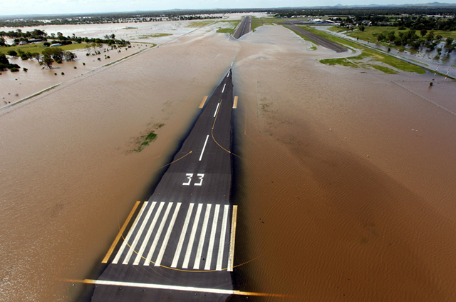 Rising floodwaters spread across the runway of the airport at Rockhampton, in eastern Queensland, Australia on January 2, 2011. MECHIELSEN LYNDON / AFP / Getty Images / boston.com