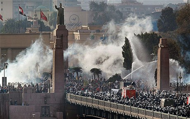 Riot police fire water cannons at protestors attempting to cross the Kasr Al Nile Bridge on January 28, 2011 in downtown Cairo. Photo: GETTY