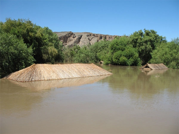 Amanzi Trails structures submerged beneath the flooded Orange River, Namibia, 18 January 2011. The Orange River reached almost 9 metres over the weekend. The water level started rising after the sluices of the Vaal and Bloemhof dams were opened in South Africa. Amanzi Trails / travelnews.com.na