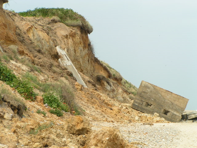 Coastal erosion at Thorpeness, Suffolk, 18 July 2005. This wartime 'pillbox' was at least 50ft from the cliff edge in 1997. No doubt it was even farther inland in the 1940s. Barry Hughes / geograph.org.uk