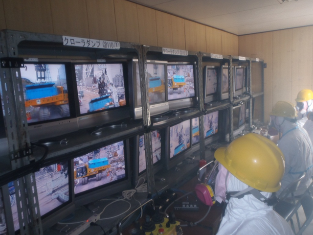 Workers at the Fukushima Daiichi nuclear plant watch monitors as they remotely operate robots in high-radiation zones. TEPCO / japannewstoday.com