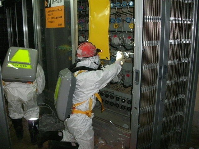 Workers inspect the status of Water Level Indicator A, in the fuel area at Unit 1, Fukushima Daiichi Nuclear Power Station, 10 May 2011. TEPCO