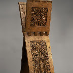 This impressive Qur’an stand, or rahla, one the most accomplished works in wood to survive from Iran, bears the signature of its carver, who was probably from Isfahan in central Iran. The splendid carved decoration, which includes the motif of a flowered bush within a niche surrounded by calligraphic blessings upon the Prophet and the Twelve Imams, reveals a Shici association. Other inscriptions include the date as well as the name of the patron who ordered this stand for a madrasa (theological school), but they do not give the name of the school or the city where it was located.