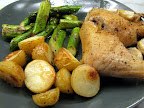 Roasted chicken leg and thigh, garlic, and potatoes and pan-sauteed asparagus. Yum! A bit unhealthy since the potatoes cook in the chicken fat, but soo tasty and easy! I put the oven on 390F, put everything except the asaparagus in a ceramic dish and baked for about 40 minutes. Pulled the chicken and garlic out because they were done and baked the potatoes for another 15 to 20 minutes.