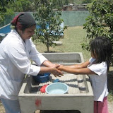 Amanda Luz washing hands before lunch with the swimming pool in the background
