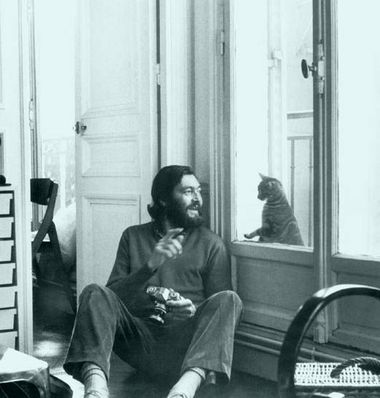 Julio Cortazar amused by a kitty.jpg