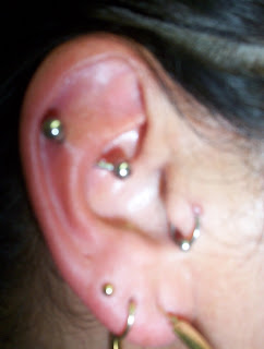 Piercing the ear with barbell and silver ring