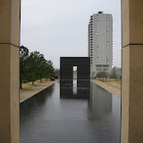 Looking between the pillars at the Oklahoma City Memorial.  On the first pillar is inscribed “9:01” and on the second pillar “9:03.”  These represent the minutes before and after the bombing.