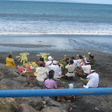 A group of locals have a religious ceremony on the beach