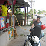 We gas up our motor scooter using a hose and gravity!