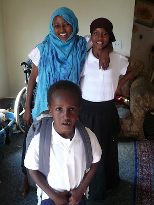 New school clothes for the first day of school!  3 Somali refugee students.  Photo by Christina Rado, Humankind