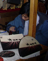 Craftsman etching a picture in wood