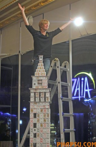 Bryan Berg of the U.S. poses at his creation of the replica of The Venetian Macao-Resort-Hotel, as he breaks his own Guinness World Record for the largest house of Freestanding playing cards at The Venetian Macau Wednesday, March 10, 2010. Bryan used 218,792 playing cards to build a replica of The Venetian Macao-Resort-Hotel during the 44 day project. The final composition is 35 feet long, 10 feet tall and weight 272kg.  (AP Photo/Kin Cheung)