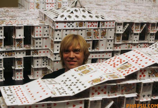 Bryan Berg of the U.S. poses at his creation of the replica of The Venetian Macao-Resort-Hotel, as he breaks his own Guinness World Record for the largest house of Freestanding playing cards at The Venetian Macau Wednesday, March 10, 2010. Bryan used 218,792 playing cards to build a replica of The Venetian Macao-Resort-Hotel during the 44 day project. The final composition is 35 feet long, 10 feet tall and weight 272kg.  (AP Photo/Kin Cheung)