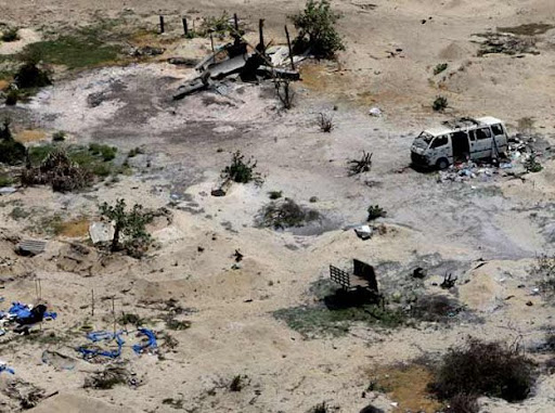 An aerial view of an abandoned vehicle is seen in the  devastation in the former conflict zone on the  north east coast of  Sri Lanka, Saturday, May 23, 2009. U.N. Secretary-General Ban Ki-moon visited the displacement camp packed with tens of thousands of Tamil civilians in northern Sri Lanka as he appealed Saturday to the triumphant government to "heal the wounds" after three decades of civil war.  (AP Photo/Kirsty Wigglesworth)