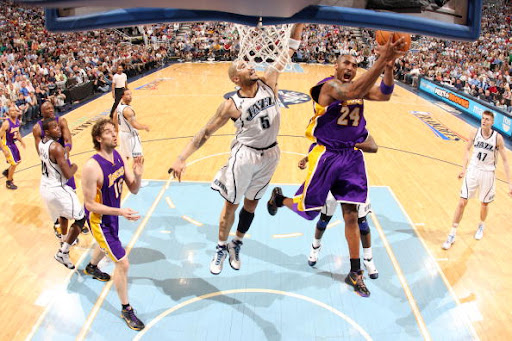 SALT LAKE CITY, UT - APRIL 23:   Kobe Bryant  #24 of the Los Angeles Lakers goes for the layup against Carlos Boozer #5 of the Utah Jazz  in Game Three of the Western Conference Quarterfinals during the 2009 NBA Playoffs at EnergySolutions Arena on April 23, 2009 in Salt Lake City, Utah. NOTE TO USER: User expressly acknowledges and agrees that, by downloading and/or using this Photograph, user is consenting to the terms and conditions of the Getty Images License Agreement. Mandatory Copyright Notice: Copyright 2009 NBAE (Photo by Melissa Majchrzak/NBAE via Getty Images)