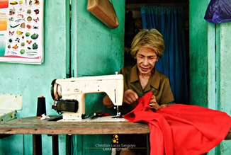 A Coron Old Timer Mends Dresses
