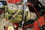 The renovated engine being put back into the car.