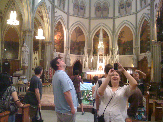 People looking up in awe and taking photographs of a beautiful cathedral-like Gothic church