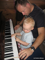 Benjamin and Andrew playing with Grandad George\'s piano.