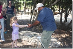 Abigail handing the pita to the taboon guy