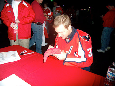 Signing my hat they gave us when we walked in...he was smiling here because my dad basically told him that I love him. lol